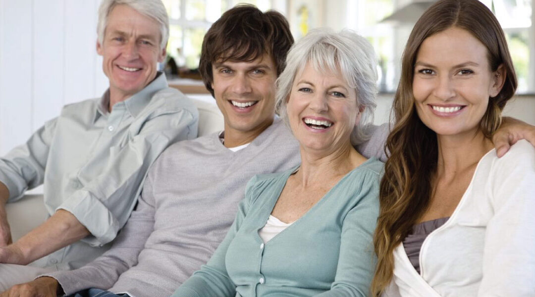 parents sitting on couch with adult children