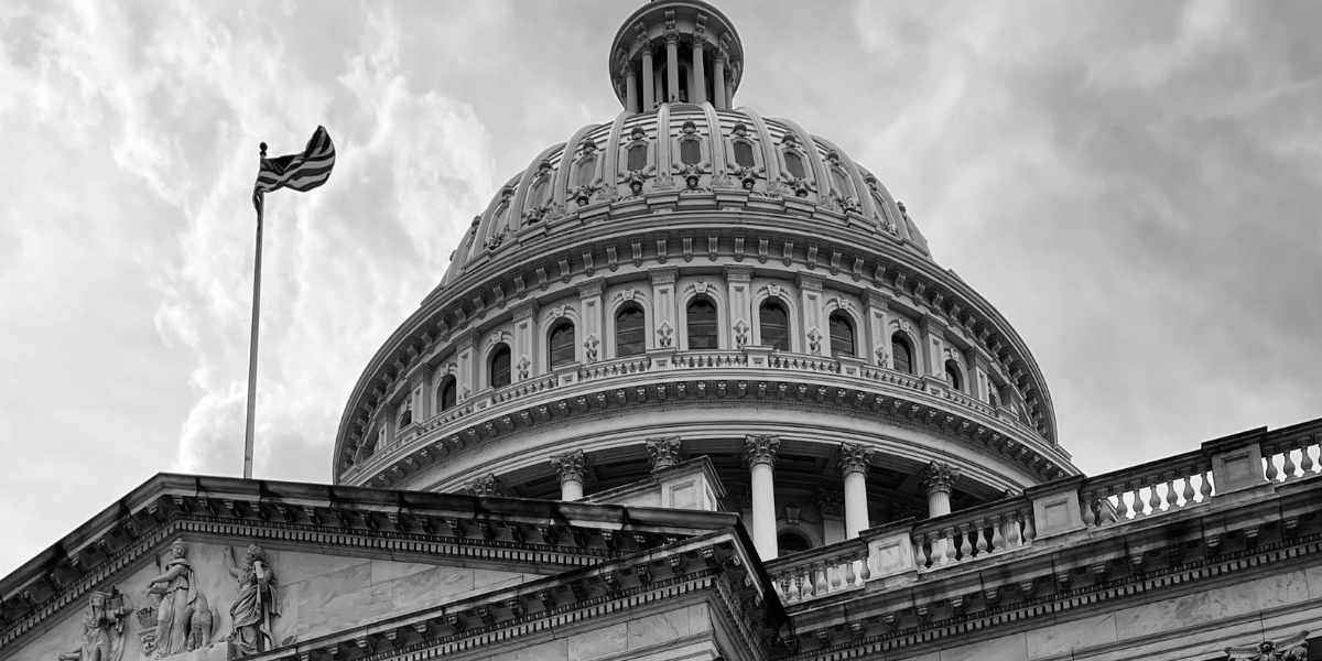 Black and white image looking up at U.S Capital dome.