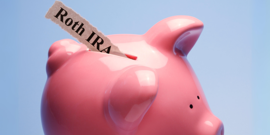 Top of piggy bank with a slip of paper that says "Roth IRA" poking out of the slot.