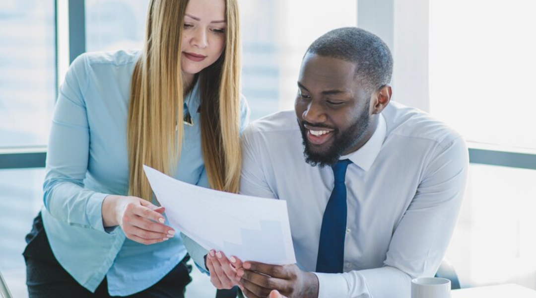 Two professionals looking over a non-qualified plan together.