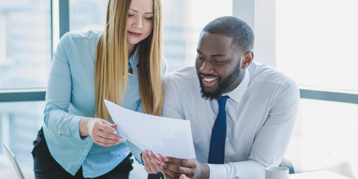 Two professionals looking over a non-qualified plan together.