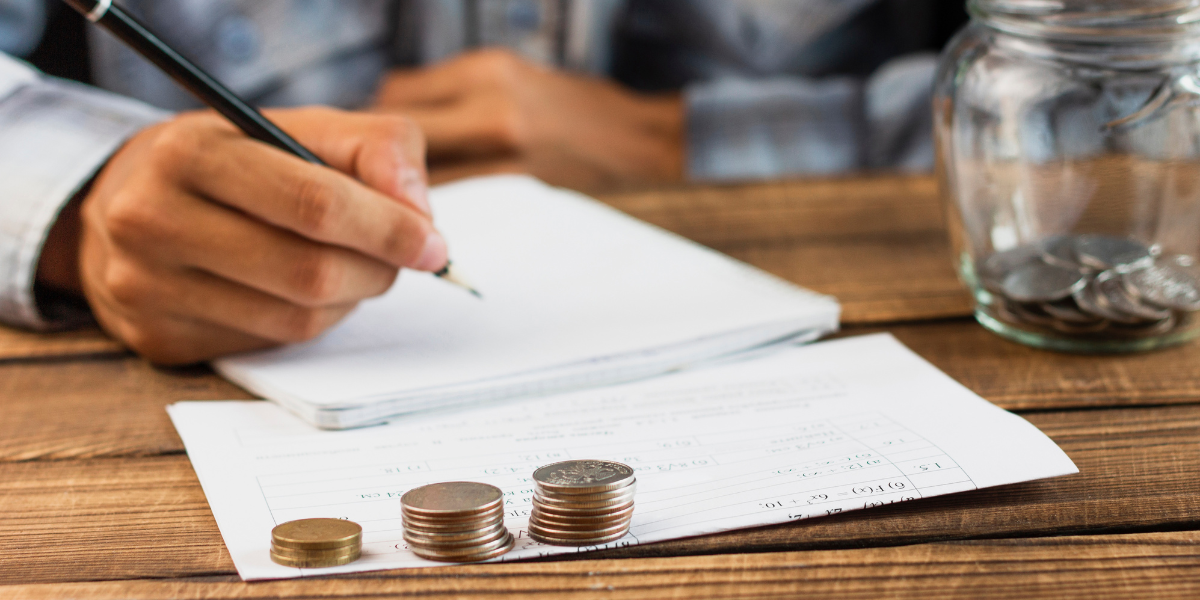 Closeup of a person using calculator while going through bills and taxes