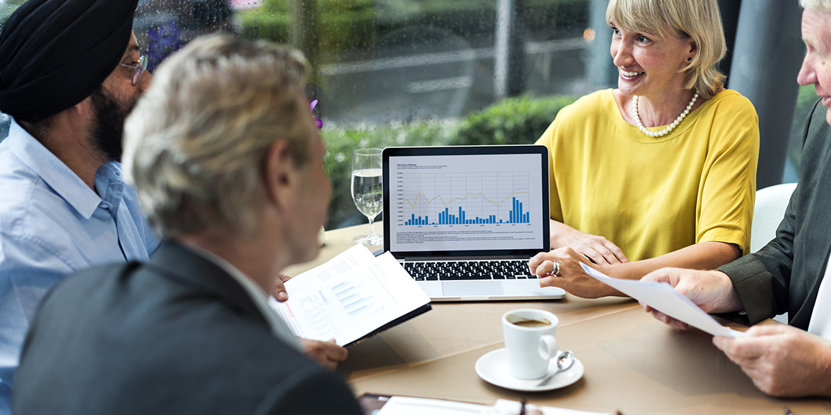 Business People Dining Together and discussing financial reports