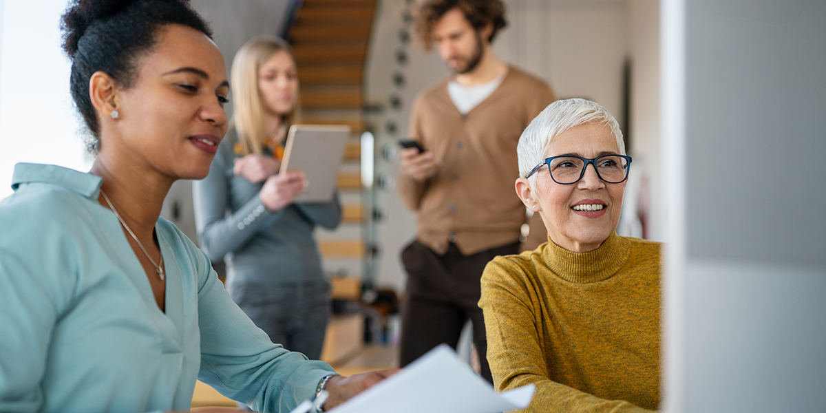 Diverse group of businesspeople discussing charts during a meeting together in a modern office
