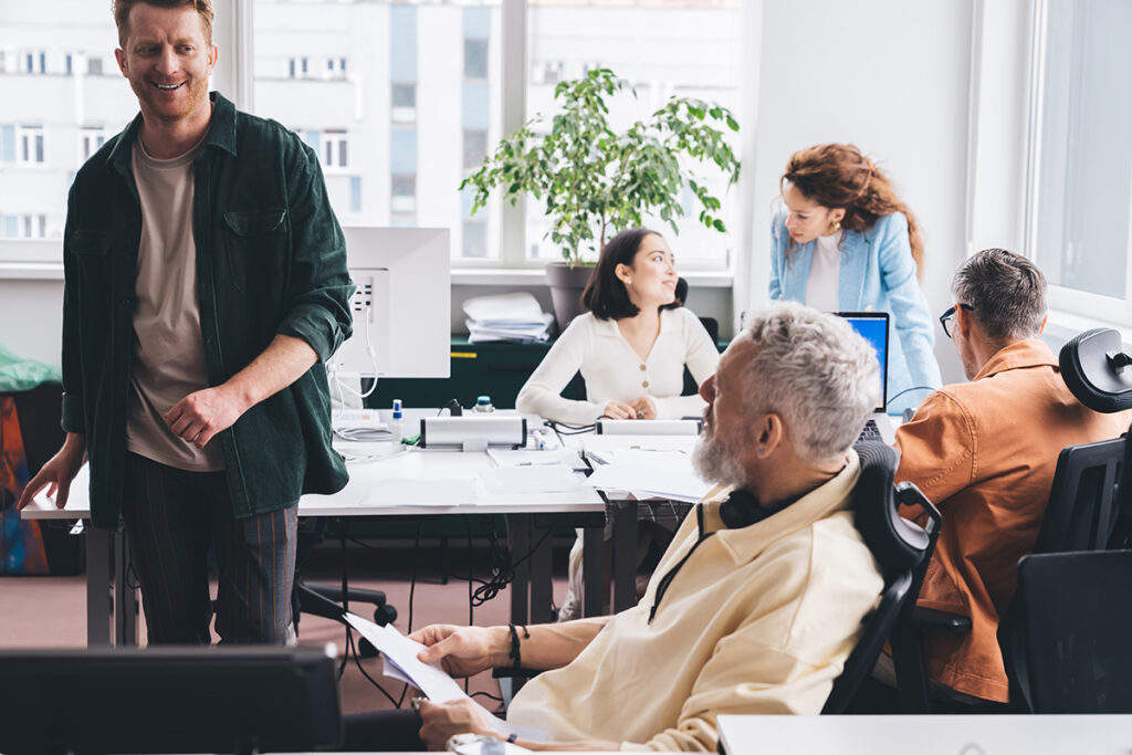 Group of diverse serious businesspeople discussing work in office